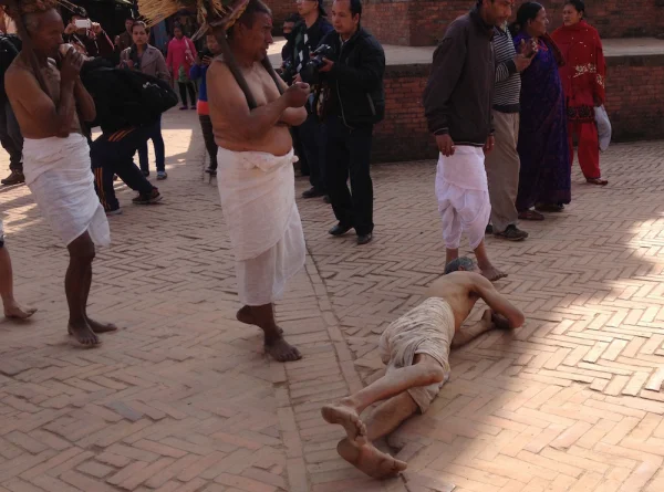Man rolling on his side through the streets of Nepal
