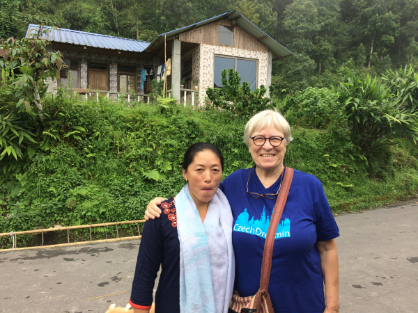 Trish standing with arm around local village woman